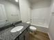 Bathroom featuring a vanity with a granite countertop, a shower-tub combo, and neutral fixtures at 12 Flatland Dr, Princeton, NC 27569