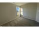 A well-lit bedroom featuring neutral walls, plush carpeting, and a window offering natural light at 12 Flatland Dr, Princeton, NC 27569