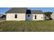 Rear exterior of a white home with a dark roof and a well-maintained lawn at 12 Flatland Dr, Princeton, NC 27569