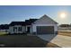 Charming single-story home featuring a well-manicured lawn, dark shutters, and a two-car garage at 12 Flatland Dr, Princeton, NC 27569