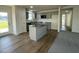 Modern kitchen boasting gray cabinets, a spacious island with granite countertops, and stainless steel appliances at 12 Flatland Dr, Princeton, NC 27569