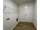 Laundry room featuring wood-look floors, a utility sink, and a doorway to the exterior at 12 Flatland Dr, Princeton, NC 27569