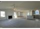 Bright and airy living room featuring a ceiling fan, a fireplace, and multiple windows for plenty of natural light at 12 Flatland Dr, Princeton, NC 27569