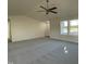 Spacious living room featuring neutral carpet, a ceiling fan, and large windows that flood the space with light at 12 Flatland Dr, Princeton, NC 27569