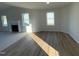 Open-concept living area with a fireplace, hardwood floors, and large windows for natural light at 12 Flatland Dr, Princeton, NC 27569