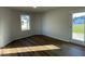 An airy room with wood-look flooring, a window providing ample natural light, and a door to the outside at 12 Flatland Dr, Princeton, NC 27569