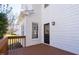 Spacious back porch features stained wood deck and entrance with black door at 1204 Matthews Glen Dr, Knightdale, NC 27545