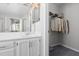 Bathroom with a white vanity with a sink, white cabinets, and a view into a walk-in closet at 1204 Matthews Glen Dr, Knightdale, NC 27545