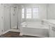 A soaking tub and a standup shower stall are featured in this bathroom at 1204 Matthews Glen Dr, Knightdale, NC 27545