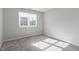 Neutral bedroom with soft carpeting and a bright window at 1204 Matthews Glen Dr, Knightdale, NC 27545