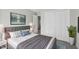 Comfortable bedroom with a soft gray bed and a spacious closet at 1204 Matthews Glen Dr, Knightdale, NC 27545