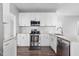 Modern kitchen with stainless steel appliances, granite countertops, and white cabinetry at 1204 Matthews Glen Dr, Knightdale, NC 27545
