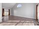 Bright living room with wood floors, featuring a large window and a unique arched window at 1204 Matthews Glen Dr, Knightdale, NC 27545