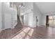 Bright open-concept living room featuring wood floors, vaulted ceiling, staircase and large windows at 1204 Matthews Glen Dr, Knightdale, NC 27545