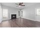 Inviting living room with fireplace, wood floors, and multiple windows for natural light at 1204 Matthews Glen Dr, Knightdale, NC 27545