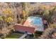 Aerial view of a community pool with a clubhouse surrounded by trees at 1204 Matthews Glen Dr, Knightdale, NC 27545