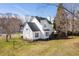 Back view of home with a large yard and mature trees at 1204 Matthews Glen Dr, Knightdale, NC 27545