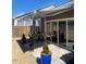 Charming backyard patio featuring an awning, seating, and a well-maintained lawn at 1216 Blue Mist Ct, Apex, NC 27502
