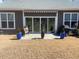 Outdoor living space featuring a stone patio, seating, and manicured lawn at 1216 Blue Mist Ct, Apex, NC 27502