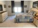 Comfortable bedroom with a large bed, neutral carpet, and natural light streaming through the window at 1216 Blue Mist Ct, Apex, NC 27502