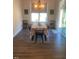 Cozy dining room featuring hardwood floors, a window, and an elegant chandelier at 1216 Blue Mist Ct, Apex, NC 27502