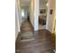 Hallway with wood floors leading to bedroom with carpet at 1216 Blue Mist Ct, Apex, NC 27502