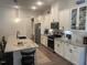 Modern kitchen with stainless steel appliances, granite countertops, and a center island at 1216 Blue Mist Ct, Apex, NC 27502