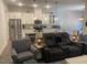 Open-concept living space with modern lighting, open to the adjacent kitchen and dining areas at 1216 Blue Mist Ct, Apex, NC 27502