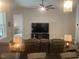 Open-concept living space with comfortable seating and ceiling fan at 1216 Blue Mist Ct, Apex, NC 27502