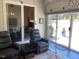 Inviting sunroom with comfortable seating and sliding glass doors to the backyard at 1216 Blue Mist Ct, Apex, NC 27502