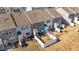 Aerial view of townhomes with fenced backyards featuring patios with outdoor seating and well-maintained landscaping at 123 Liam St, Clayton, NC 27520