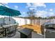 Cozy backyard featuring a patio with umbrella, grill, and well-maintained lawn and fence at 123 Liam St, Clayton, NC 27520