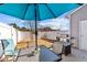Backyard featuring a grill, a table with umbrella, and a white fence at 123 Liam St, Clayton, NC 27520