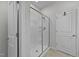 Bright bathroom featuring a shower stall with glass door and white walls at 123 Liam St, Clayton, NC 27520