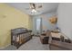 Cozy bedroom featuring a crib, an armchair, and a ceiling fan at 123 Liam St, Clayton, NC 27520