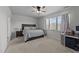 Well-lit bedroom with a ceiling fan, carpet, and a comfortable bed and neutral decor at 123 Liam St, Clayton, NC 27520