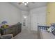 Cozy bedroom featuring a gray dresser and view into the ensuite bathroom at 123 Liam St, Clayton, NC 27520