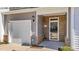 Inviting front door with brick detail, garage, and security system at 123 Liam St, Clayton, NC 27520