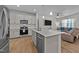 Modern kitchen with stainless appliances, tile backsplash, and center island that overlooks the living area at 123 Liam St, Clayton, NC 27520