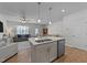 Open kitchen concept with stainless steel dishwasher and center island with a double basin sink at 123 Liam St, Clayton, NC 27520