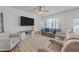 Bright living room with large TV, modern furniture, ceiling fan and natural light at 123 Liam St, Clayton, NC 27520