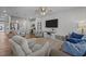 Open concept living room and kitchen, featuring a ceiling fan, recessed lights, and modern furniture at 123 Liam St, Clayton, NC 27520