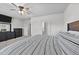 Bright main bedroom featuring a ceiling fan, a dresser, and an ensuite bathroom at 123 Liam St, Clayton, NC 27520
