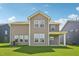 Backyard view of a two story home with an ample yard at 124 Willow Cameron Way, Angier, NC 27501