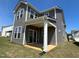 Backyard featuring gray siding and a covered patio, perfect for relaxing and entertaining at 124 Willow Cameron Way, Angier, NC 27501
