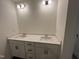 A bathroom with a double sink vanity and white shaker cabinets at 124 Willow Cameron Way, Angier, NC 27501