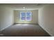 A bedroom with neutral carpet and two large windows at 124 Willow Cameron Way, Angier, NC 27501