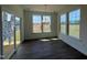 Bright dining room features multiple windows, hardwood floors, and modern chandelier lighting at 124 Willow Cameron Way, Angier, NC 27501
