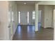 Entryway view showcasing wood floors, closet space, half-bath, and glass paneled doors to an office at 124 Willow Cameron Way, Angier, NC 27501