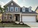 Beautiful two-story home featuring a brick and siding exterior, attached two car garage and landscaped front yard at 124 Willow Cameron Way, Angier, NC 27501